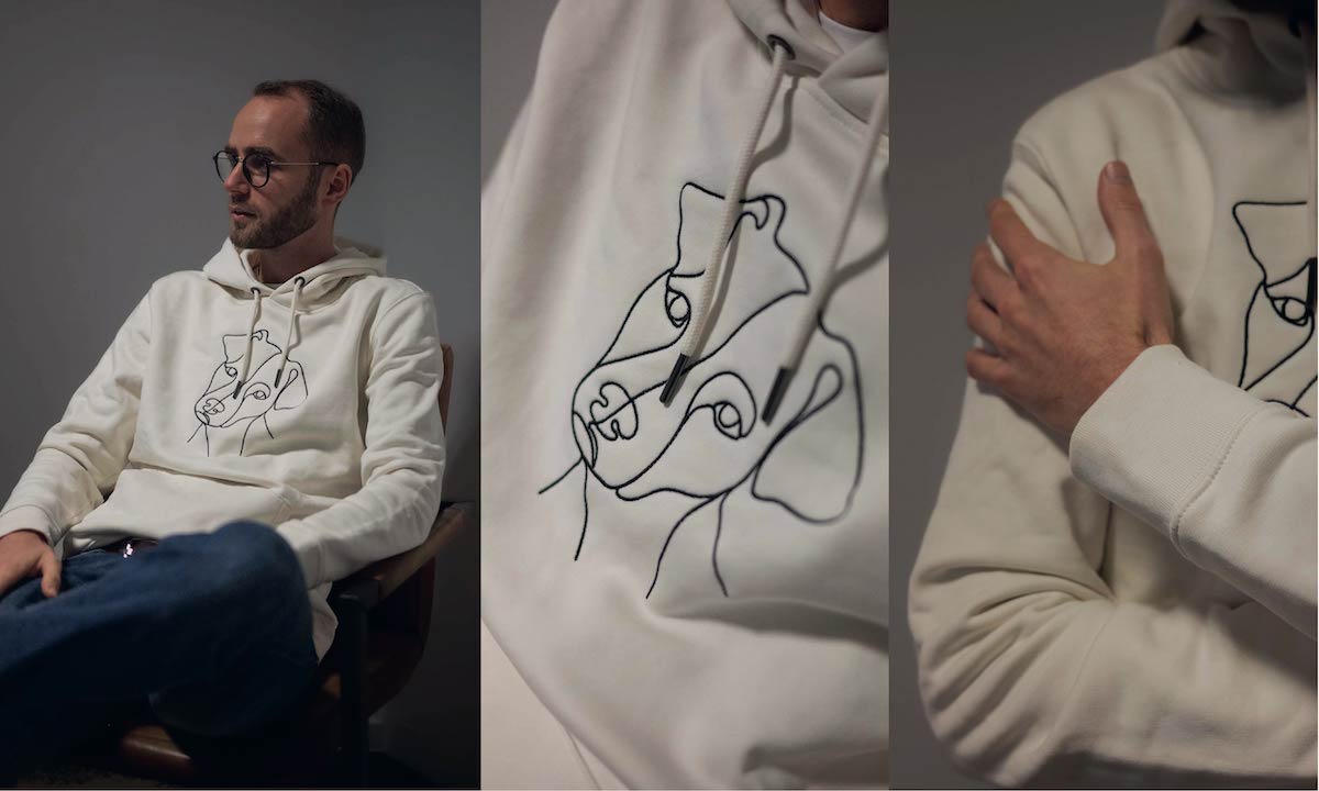 Broderad hoodie med hundmotiv, närbild av broderiet